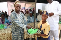 A school principal at the event presenting scholarship to one of the students that benefit from the programme