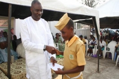 Mr Gbenga Atiba presenting scholarship to a student